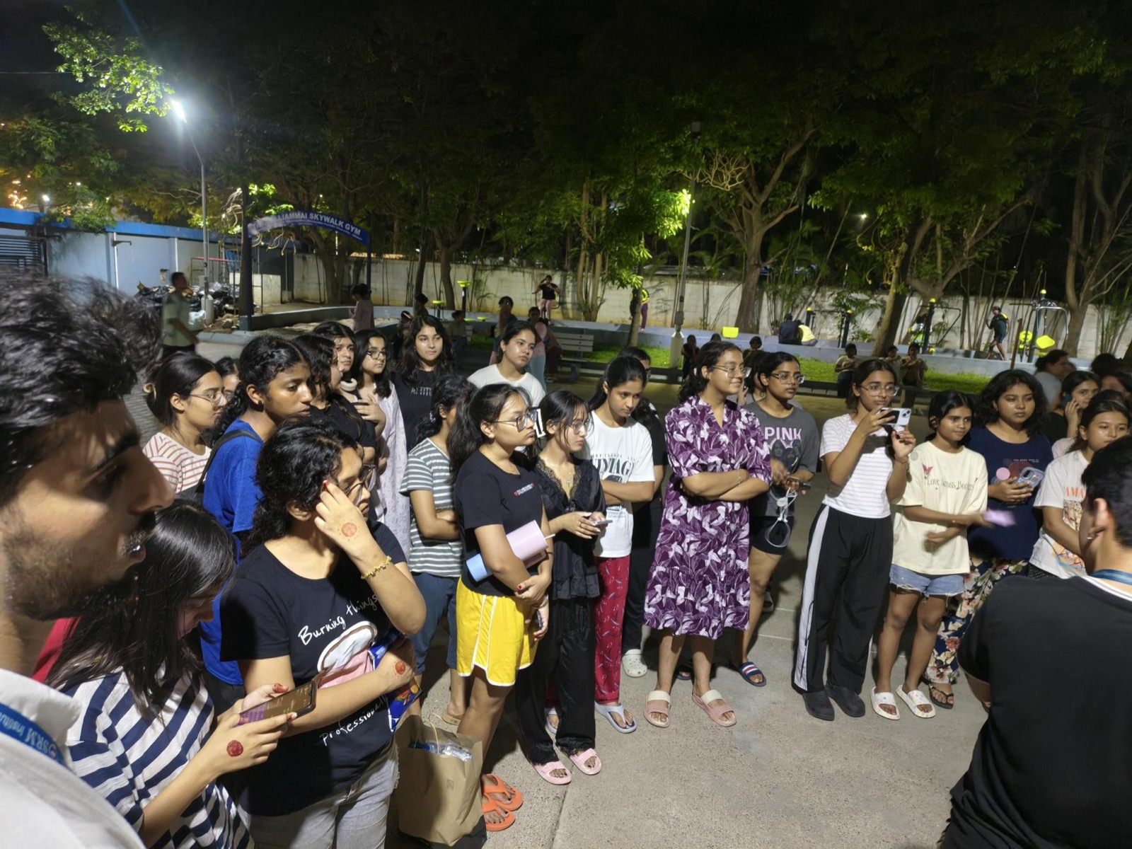 Students gathered around the DEI team during the hostel entrepreneurship outreach