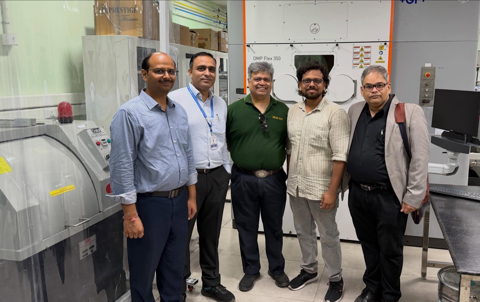 The visiting team at the DMP Flex 350 metal 3D printer in the mPragati Centre workshop