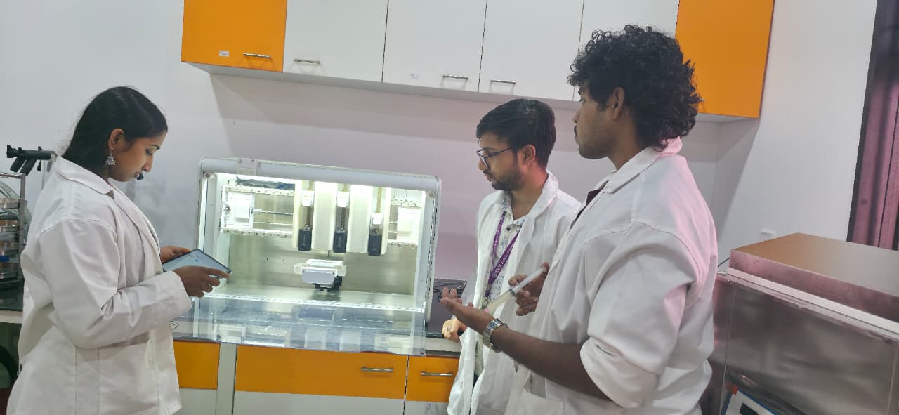 Interns working on the 3D bioprinter at BioNEST